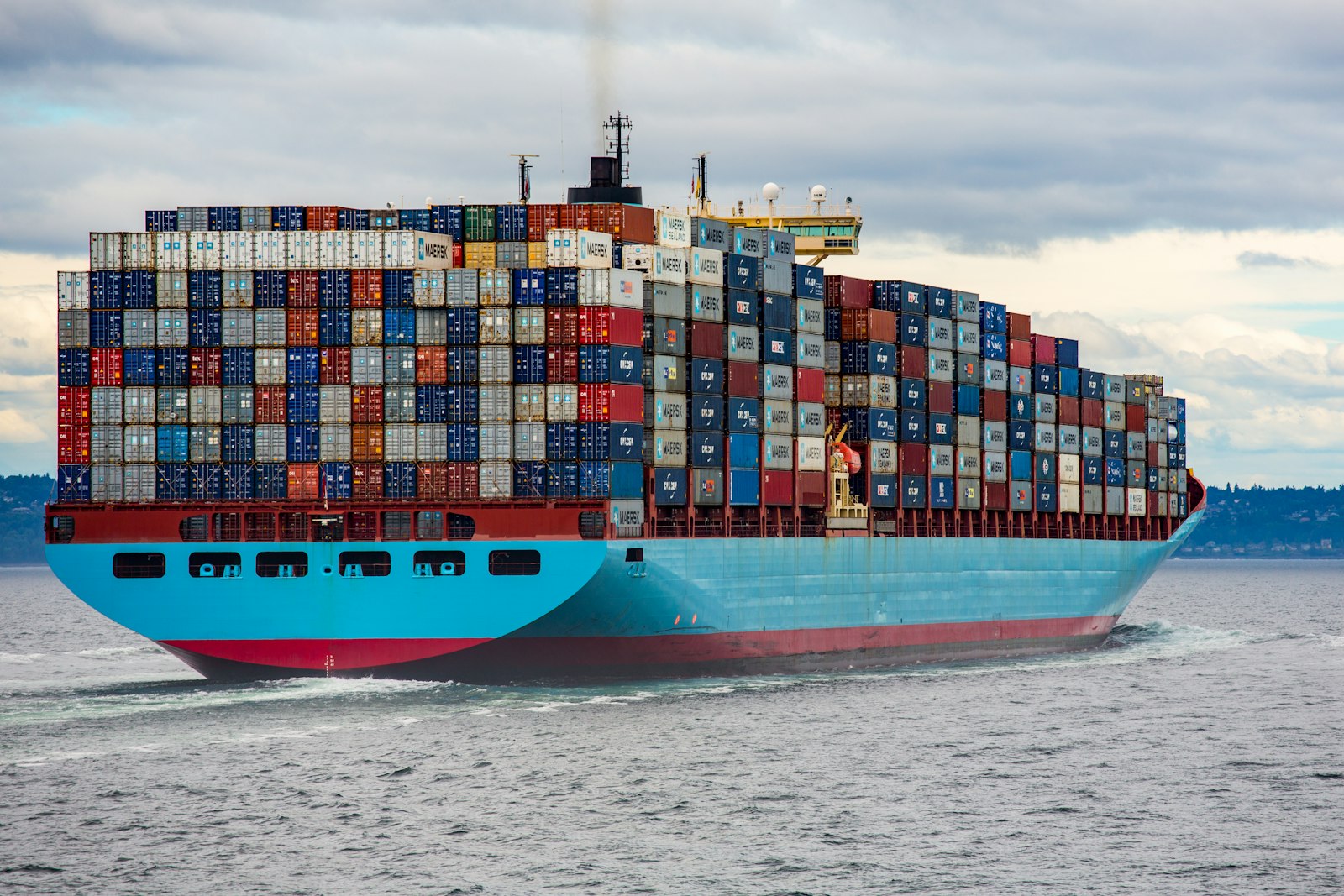 Lifting Equipments — a container ship at port, heavy industry and global lifting logistics